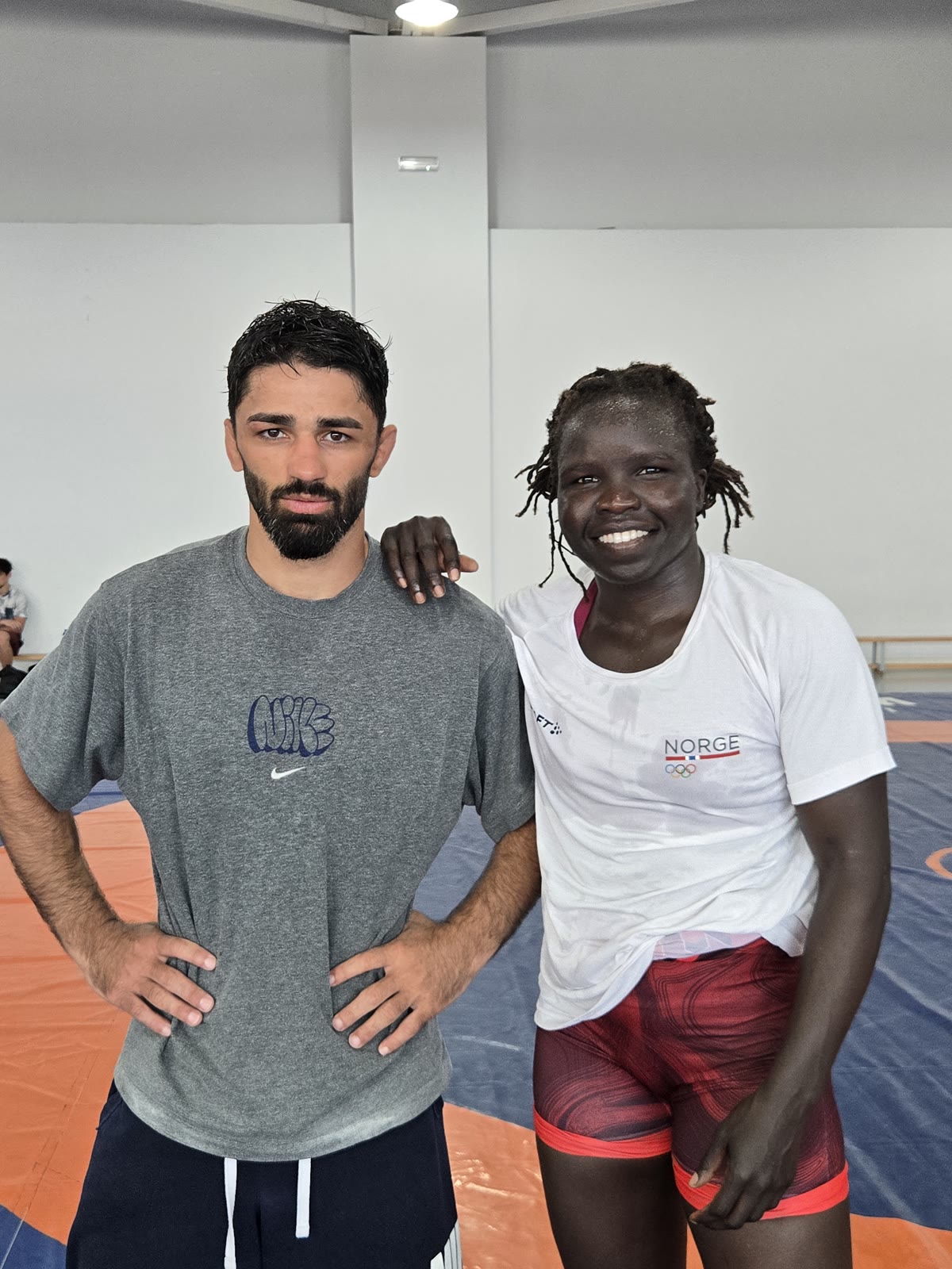 A Georgian coach with a visiting wrestler from Team Norway